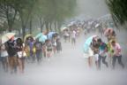 People hold umbrellas in heavy rain as Typhoon Soudelor approaches, in Hangzhou