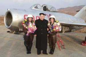 North Korean leader Kim Jong Un poses for pictures with pilots as he provides field guidance to the flight drill of female pilots of pursuit planes of the KPA Air and Anti-Air Force