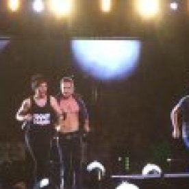 louis-tomlinson-sips-liam-paynes-shirt-open-in-middle-of-concert-video-ftr